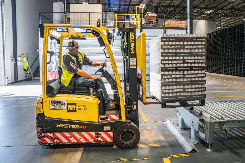 An employee operating a forklift in a warehouse.